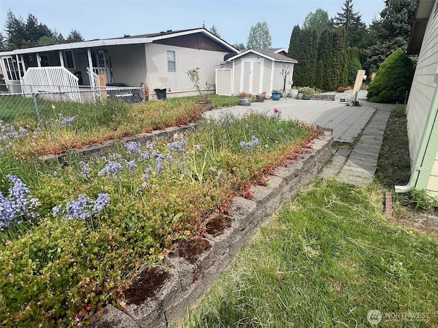 156 NE Zodiac Ln, Bremerton, WA 98311 - view of yard featuring a storage shed, an outdoor structure, and fence