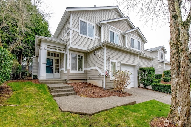 view of front facade with an attached garage, a front lawn, and concrete driveway