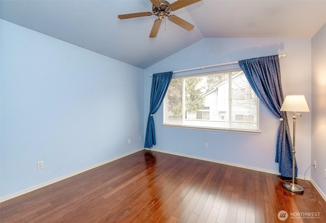unfurnished room with wood finished floors, ceiling fan, baseboards, and vaulted ceiling