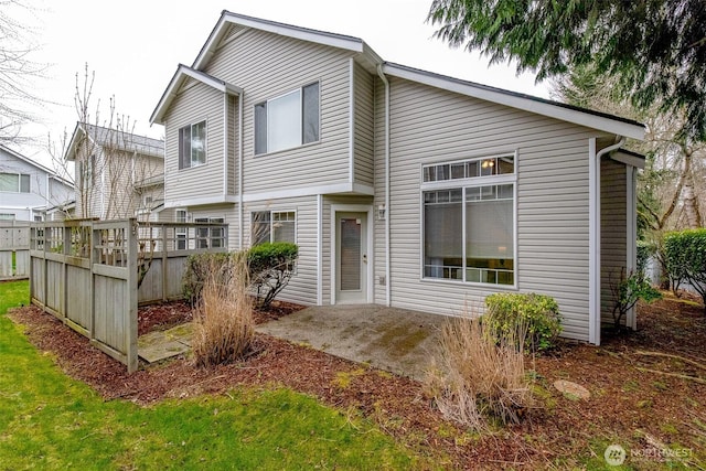 view of front of home featuring a patio area and fence