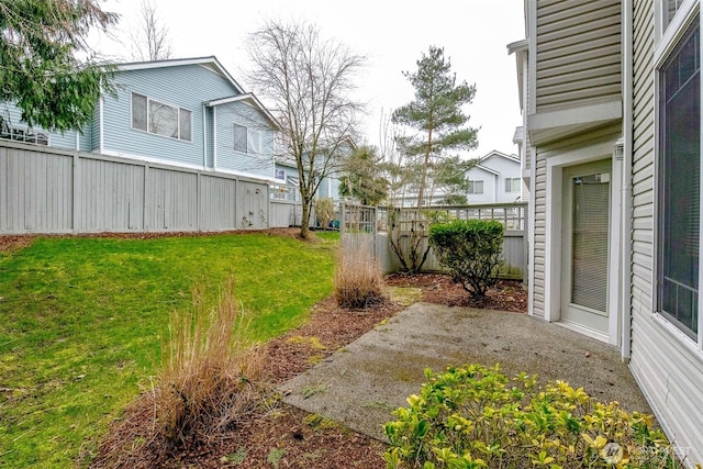 view of yard featuring a patio area and a fenced backyard