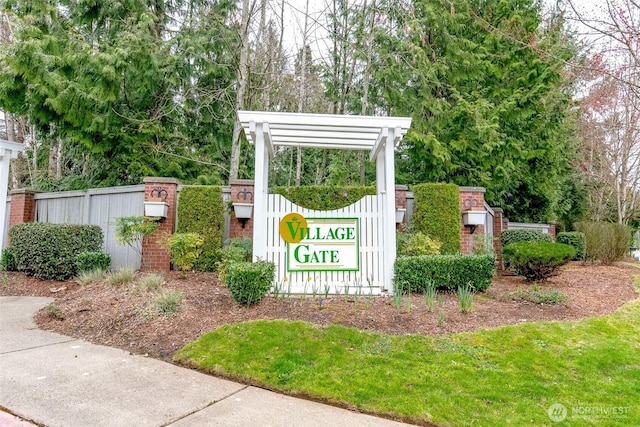 community / neighborhood sign featuring fence