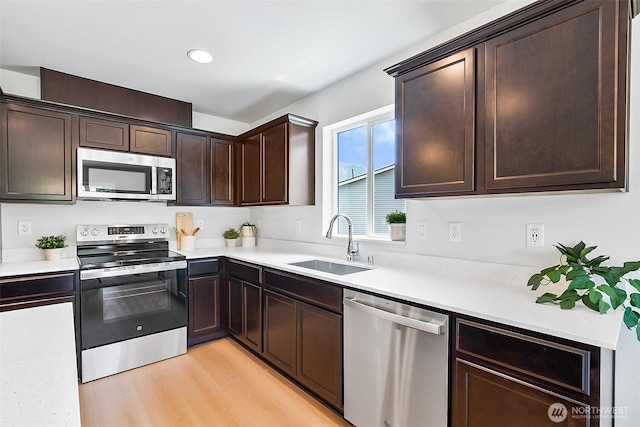 1512 Alder Ln, Gold Bar, WA 98251 - kitchen featuring stainless steel appliances, dark brown cabinetry, light countertops, light wood-type flooring, and recessed lighting