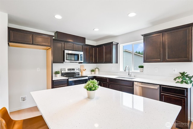 1512 Alder Ln, Gold Bar, WA 98251 - kitchen featuring stainless steel appliances, dark brown cabinetry, a center island, recessed lighting, and wood finished floors