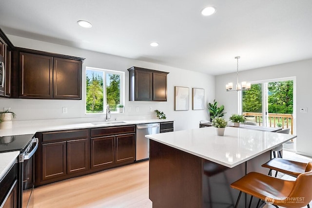 1512 Alder Ln, Gold Bar, WA 98251 - kitchen with electric stove, dishwasher, dark brown cabinetry, plenty of natural light, and recessed lighting