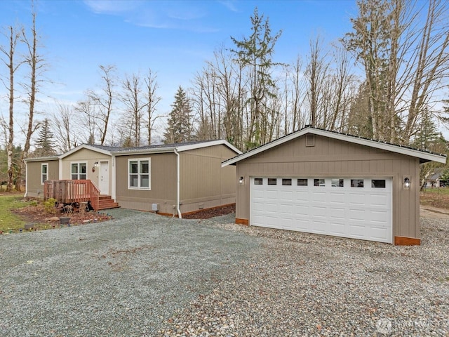 view of front of house with an outbuilding, crawl space, a garage, and a wooden deck