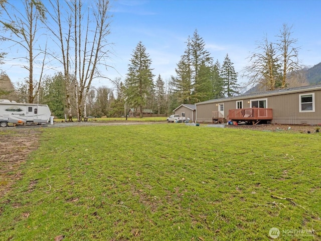 view of yard with a wooden deck