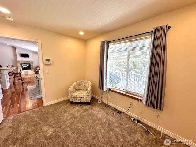 living area with baseboards, a fireplace, recessed lighting, and carpet