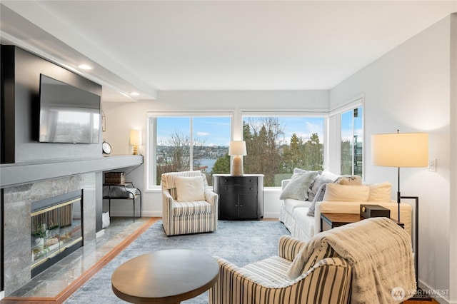 living room with recessed lighting, a fireplace, and baseboards