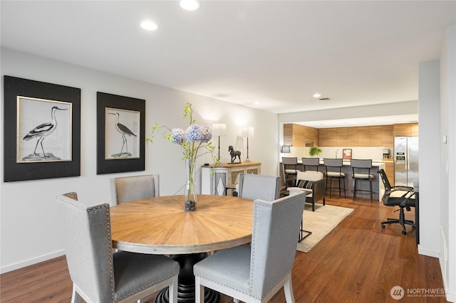 dining area featuring recessed lighting, wood finished floors, and baseboards