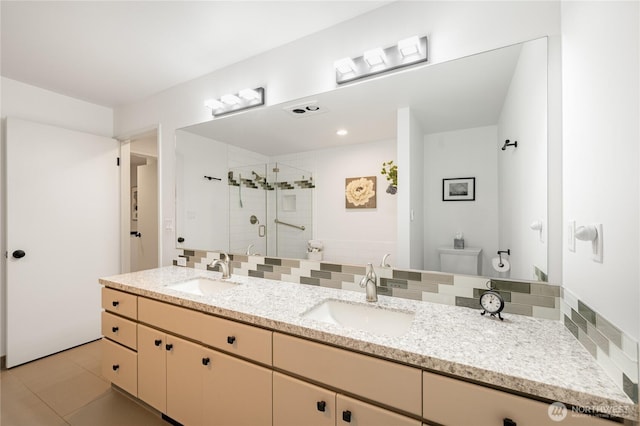 full bath with tile patterned floors, a shower stall, double vanity, and a sink