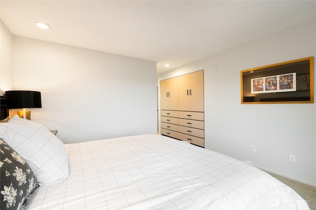 carpeted bedroom with recessed lighting