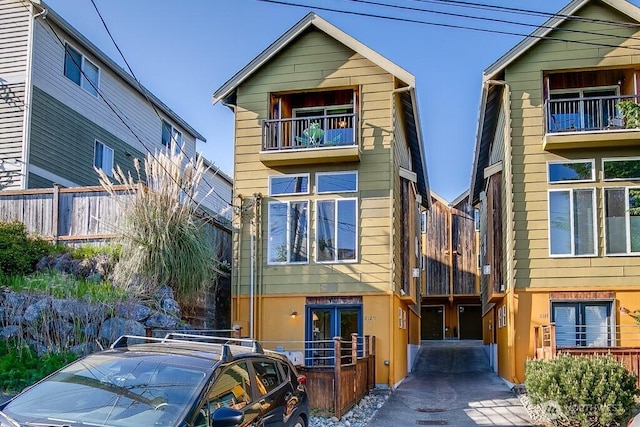 2120 W Ruffner St, Seattle, WA 98199 - view of front of house featuring fence, french doors, and a balcony