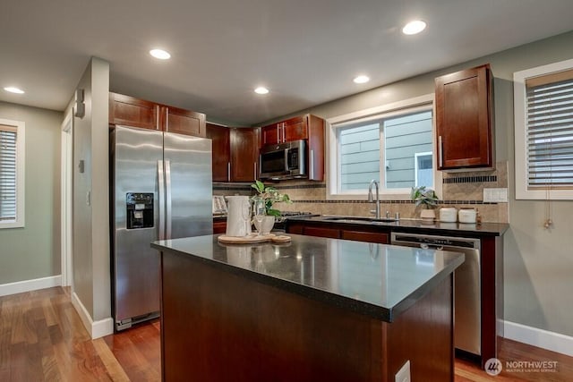 2120 W Ruffner St, Seattle, WA 98199 - kitchen with decorative backsplash, baseboards, appliances with stainless steel finishes, and a sink