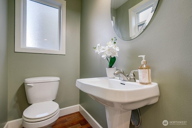 2120 W Ruffner St, Seattle, WA 98199 - half bathroom with wood finished floors, baseboards, a sink, and toilet