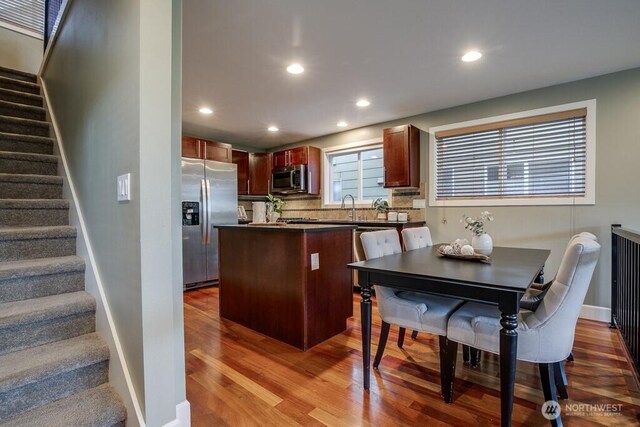 2120 W Ruffner St, Seattle, WA 98199 - kitchen featuring dark countertops, appliances with stainless steel finishes, wood finished floors, and recessed lighting