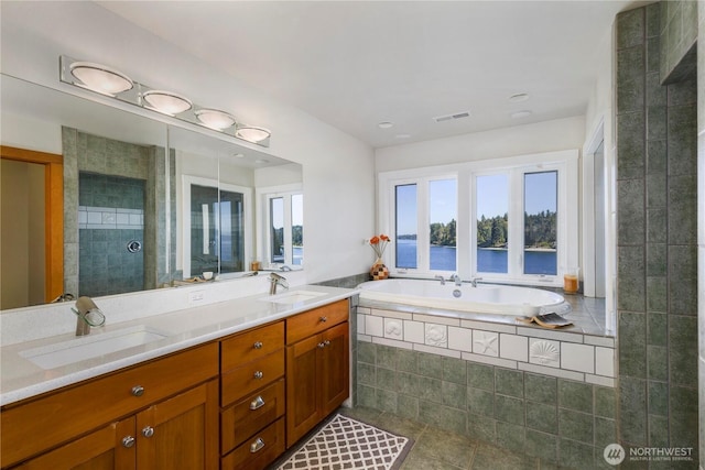 17884 S Angeline Ave NE, Suquamish, WA 98392 - full bath featuring tile patterned flooring, a bath, double vanity, a water view, and tiled shower