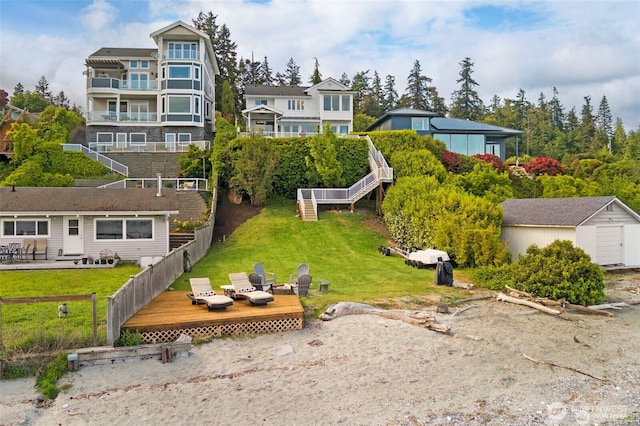 17884 S Angeline Ave NE, Suquamish, WA 98392 - rear view of property featuring a wooden deck, a garage, and a storage unit
