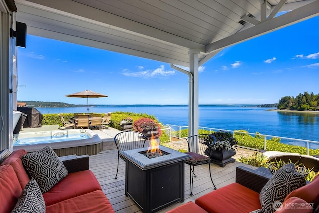 17884 S Angeline Ave NE, Suquamish, WA 98392 - wooden terrace featuring a water view, a hot tub, and an outdoor living space with a fire pit