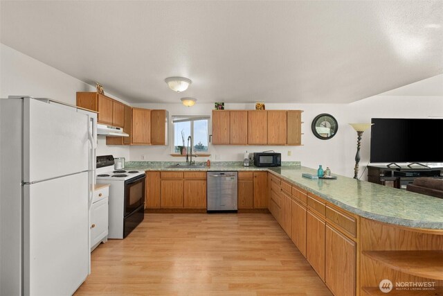 1412 Storm King Ave, Ocean Shores, WA 98569 - kitchen featuring freestanding refrigerator, electric stove, stainless steel dishwasher, under cabinet range hood, and black microwave
