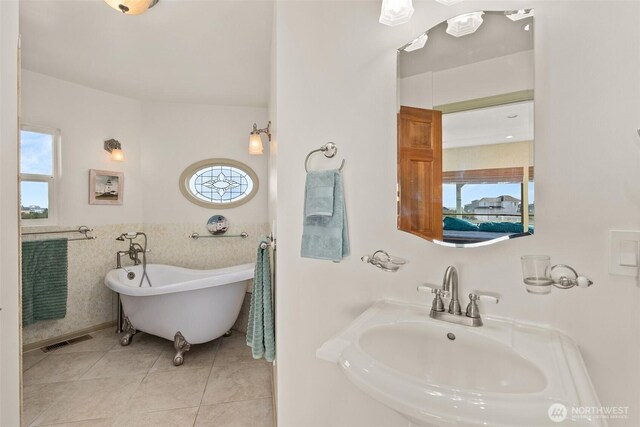 1412 Storm King Ave, Ocean Shores, WA 98569 - full bath with a sink, healthy amount of natural light, a freestanding tub, tile patterned floors, and tile walls
