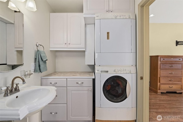 1412 Storm King Ave, Ocean Shores, WA 98569 - laundry area featuring stacked washing machine and dryer and wood finished floors