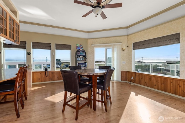 1412 Storm King Ave, Ocean Shores, WA 98569 - dining area featuring crown molding, wood finished floors, ceiling fan, a wainscoted wall, and wood walls
