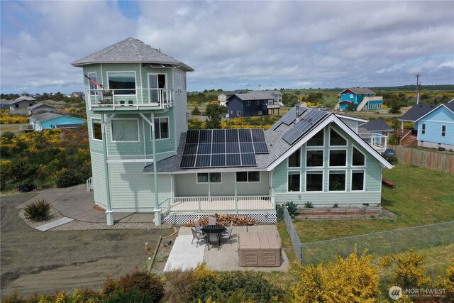 1412 Storm King Ave, Ocean Shores, WA 98569 - back of house with solar panels, a balcony, a patio, a shingled roof, and a residential view
