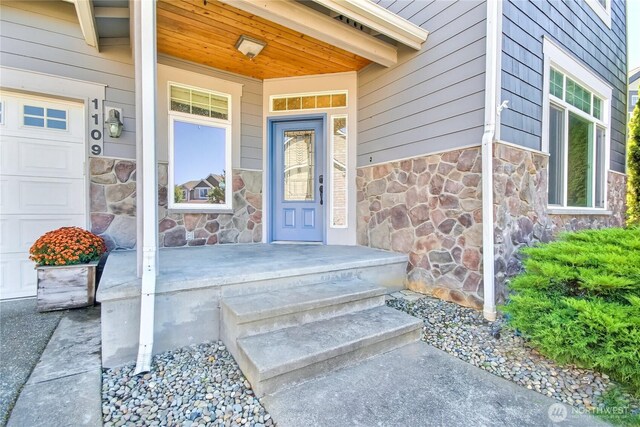 doorway to property with stone siding