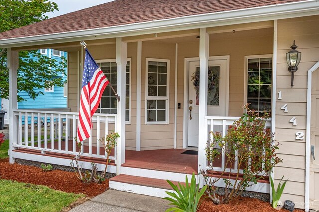 1442 SW Ponsteen Dr, Oak Harbor, WA 98277 - doorway to property featuring a porch and a shingled roof