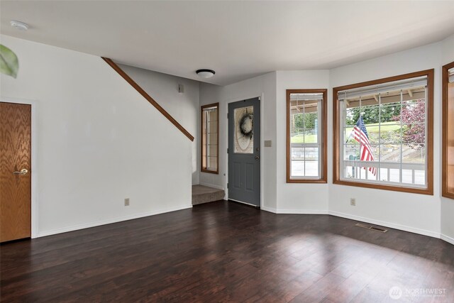 1442 SW Ponsteen Dr, Oak Harbor, WA 98277 - foyer entrance with dark wood-style flooring, baseboards, and stairs