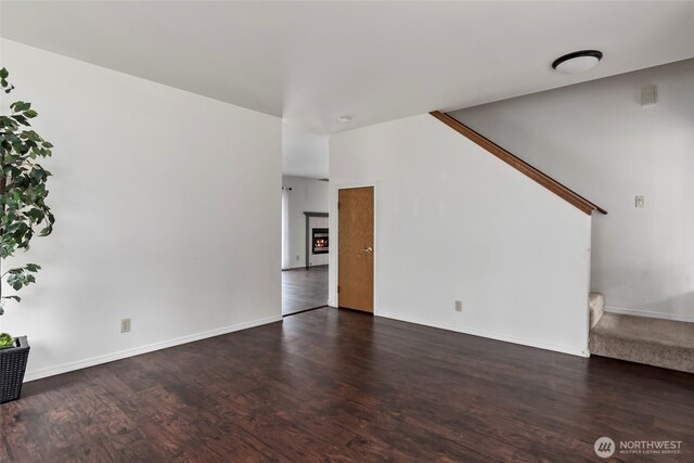 1442 SW Ponsteen Dr, Oak Harbor, WA 98277 - unfurnished living room featuring stairs, wood finished floors, and baseboards