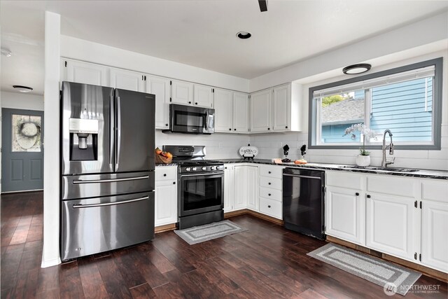 1442 SW Ponsteen Dr, Oak Harbor, WA 98277 - kitchen featuring appliances with stainless steel finishes, a sink, dark wood-style floors, tasteful backsplash, and white cabinetry