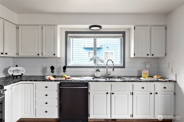 1442 SW Ponsteen Dr, Oak Harbor, WA 98277 - kitchen with black dishwasher, a sink, white cabinets, backsplash, and dark stone countertops