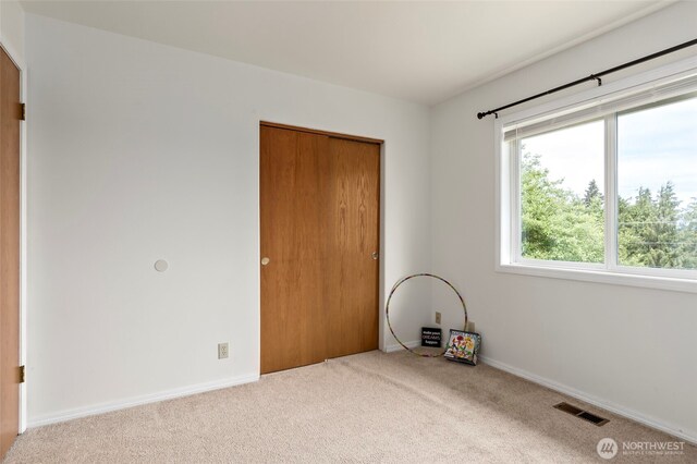 1442 SW Ponsteen Dr, Oak Harbor, WA 98277 - unfurnished bedroom with carpet flooring, baseboards, and a closet