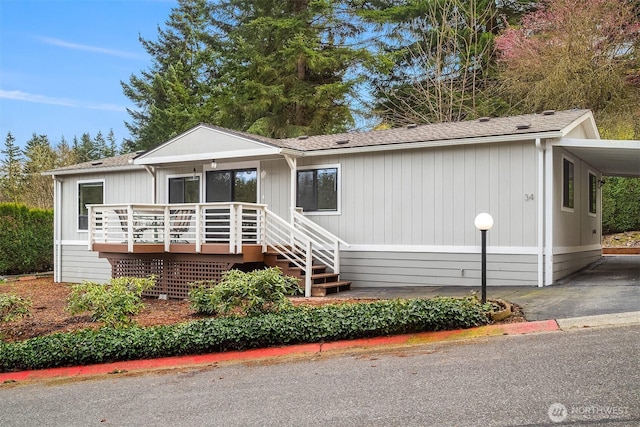 manufactured / mobile home featuring an attached carport and driveway
