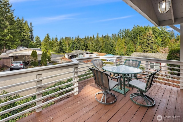 wooden terrace with outdoor dining space