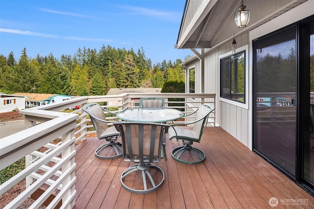 wooden terrace with outdoor dining space