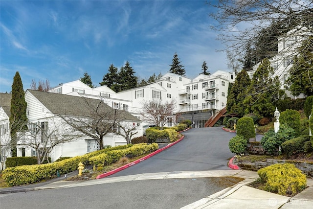 3990 129th Pl SE Unit 302, Bellevue, WA 98006 - view of asphalt road featuring curbs, a residential view, and sidewalks