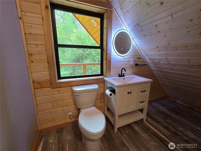 315 Skate Creek Rd N, Ashford, WA 98304 - bathroom featuring wood finished floors, toilet, plenty of natural light, wooden walls, and lofted ceiling