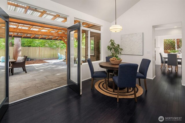 12423 NE 70th St, Kirkland, WA 98033 - dining area featuring baseboards, lofted ceiling, and dark wood-style flooring