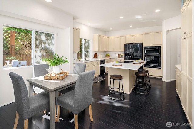 12423 NE 70th St, Kirkland, WA 98033 - kitchen featuring black appliances, light countertops, a center island, healthy amount of natural light, and recessed lighting