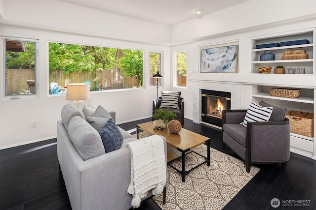 12423 NE 70th St, Kirkland, WA 98033 - living room featuring wood finished floors, plenty of natural light, a glass covered fireplace, and baseboards