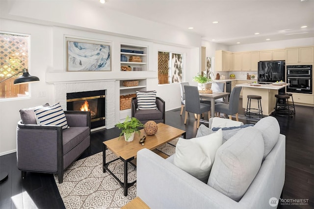 12423 NE 70th St, Kirkland, WA 98033 - living room featuring light wood finished floors, recessed lighting, a fireplace, baseboards, and built in features