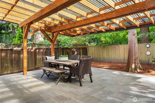 12423 NE 70th St, Kirkland, WA 98033 - view of patio with outdoor dining space, a fenced backyard, and a pergola