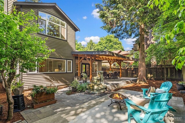 12423 NE 70th St, Kirkland, WA 98033 - view of patio with a fire pit, a fenced backyard, and outdoor dining space