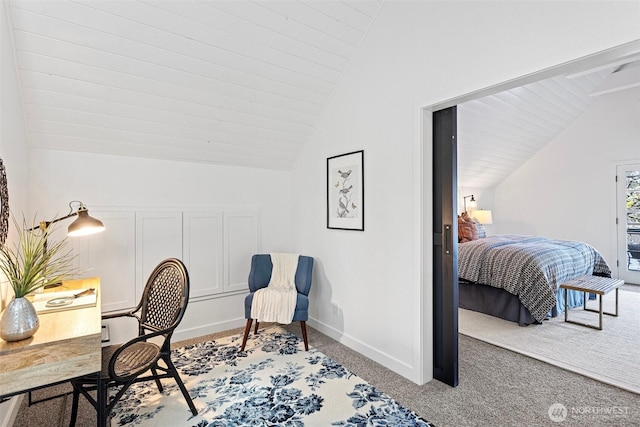 office space with baseboards, vaulted ceiling, and carpet