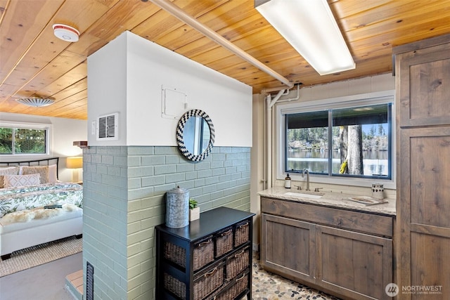 bathroom featuring vanity, wood ceiling, tile walls, and visible vents