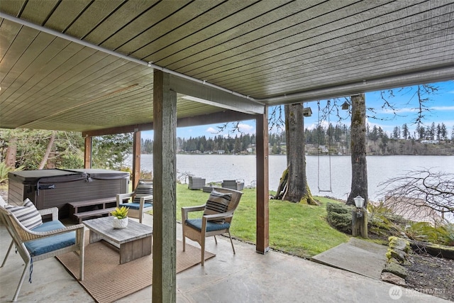 view of patio with a water view and a hot tub