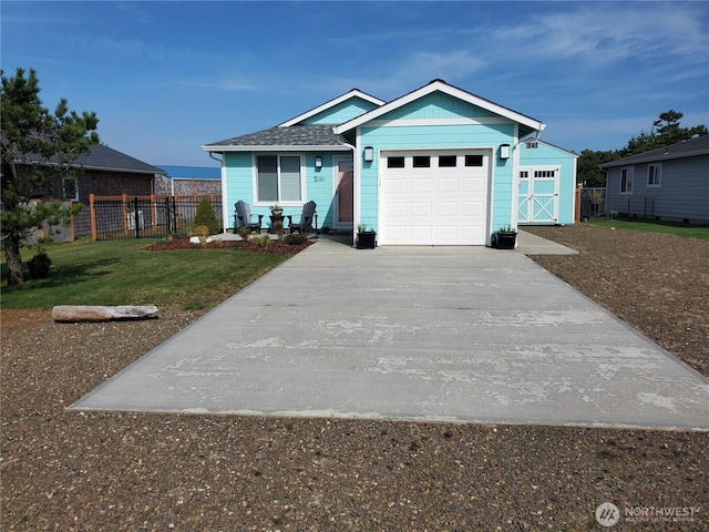 801 340th Pl, Ocean Park, WA 98640 - view of front of house featuring a front yard, driveway, fence, and an attached garage